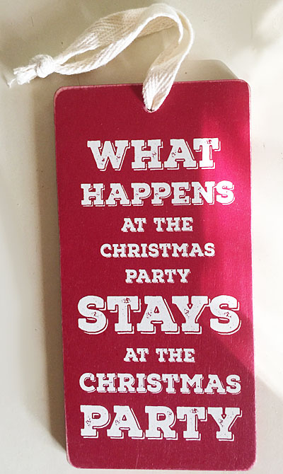Real Christmas ornament that says What happens at the Christmas party, stays at the Christmas party. A funny photo.