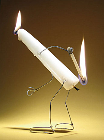 A candle burns itself at both ends - a funny photo