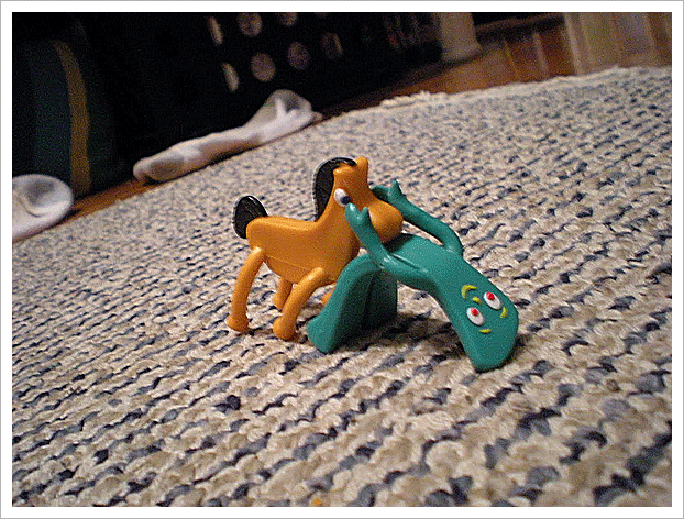 Gumby and his horse doing a strange yoga pose, a funny cartoon