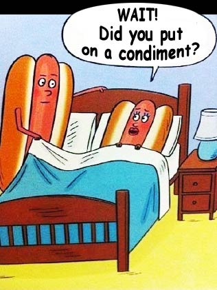 Two hot dogs in bed, one wonders about the condiment