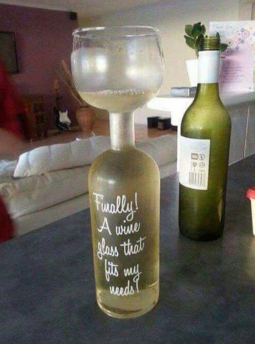 Top of bottle has a wine glass attached. It says Finally a wine glass that fits my needs on the bottle. A cute cartoon