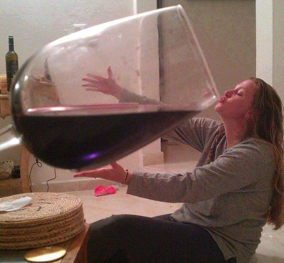 Glass of red wine as big as a bathtub.